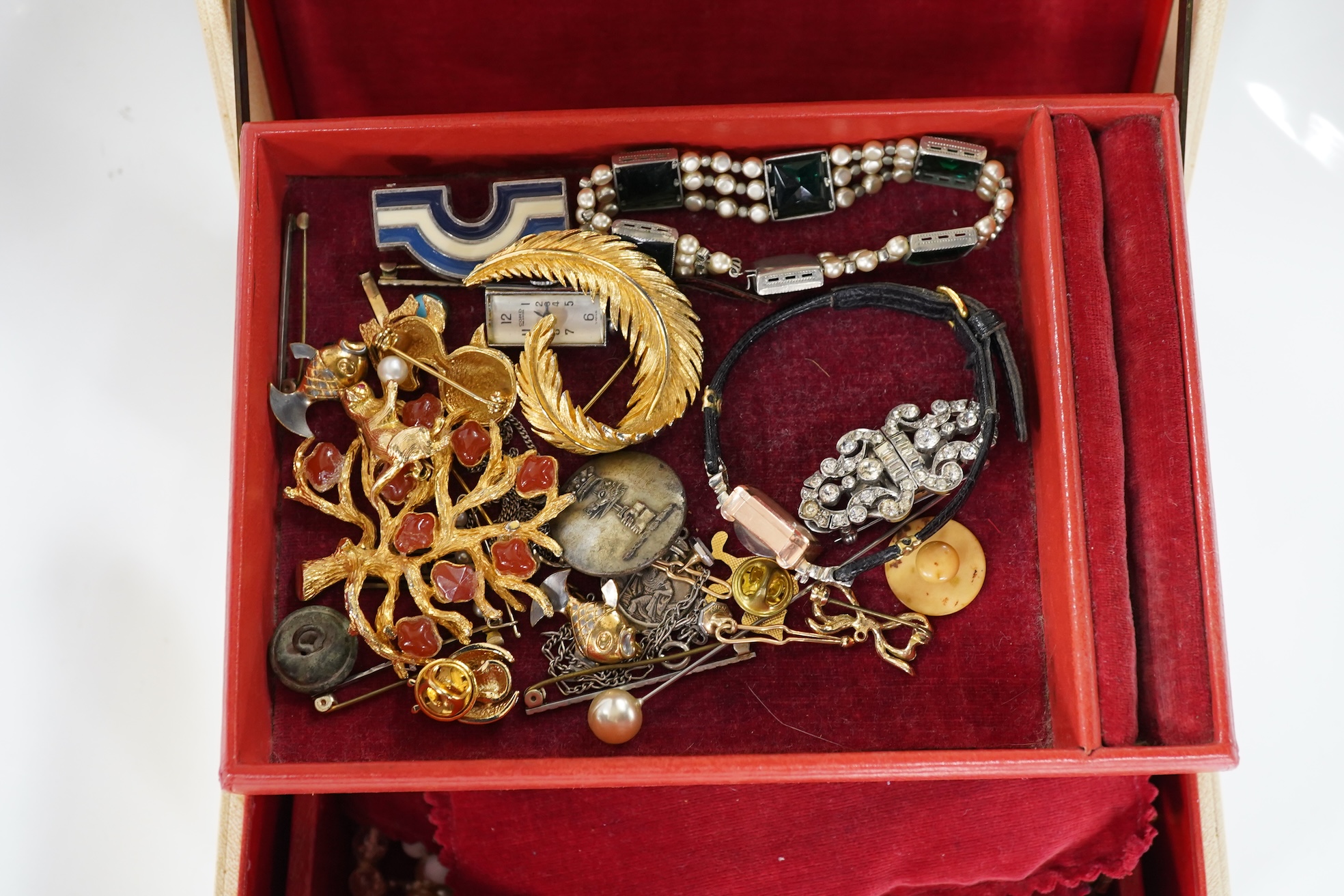 A lady's Retro gold watch by DelBana, 1940s, the square dial in a rose gold case accented with rubies, stamped 14K, to a black cord strap; together with a collection of assorted costume jewels, in a two-tiered white leat